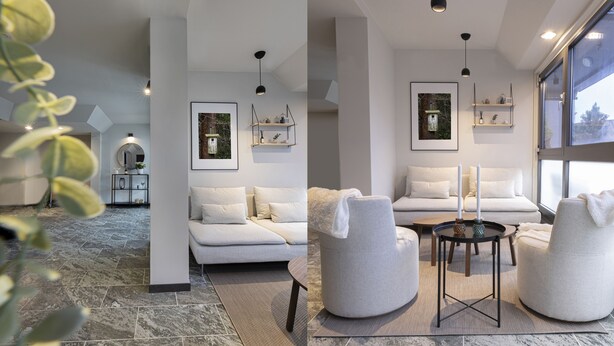 A modern living room with a sofa, two armchairs, a coffee table, and a fireplace. There are framed pictures on the wall and a small shelf with decorative items. - Jönköping Hotel Apartments (Jonkoping)