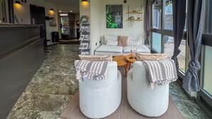 A reception area with a marble floor, a sofa set, a coffee table, and a vending machine labeled "HOOM". - Jönköping Hotel Apartments (Jonkoping)
