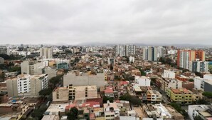 A dense urban area with a mix of residential and commercial buildings, including high-rise apartments and smaller structures.