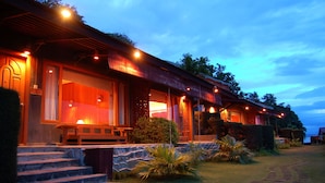 A hotel with a stone facade, wooden steps, and a covered porch area. - Bagan Thande Hotel (Nyaung-U)