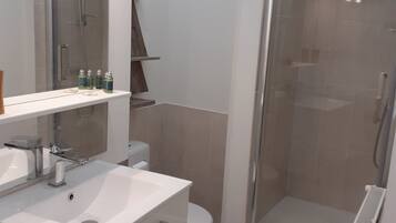 Shower, hair dryer, towels, toilet paper