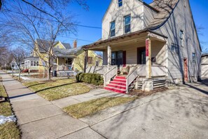 A two-story house with a front porch, a small front yard, and a sidewalk. - North St Neighborhood Character Home Near Downtown (Appleton)