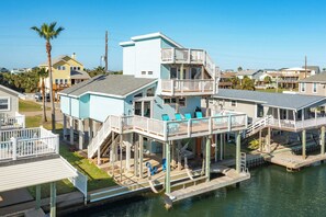 A waterfront property with multiple decks and a dock extending into the water.