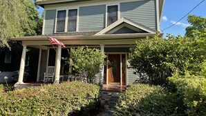 A two-story house with a porch, a front door, and a small front yard. - 2/2 Apt downtown in restored historic home yr 1891 (Ocala)