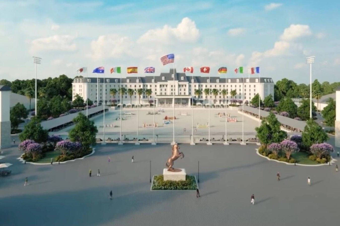 A large hotel with multiple flags, a central statue, and a spacious courtyard.