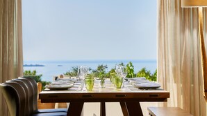 A table set for dining with a view of the sea. -  Grace Villas Collection (Hersonissos)