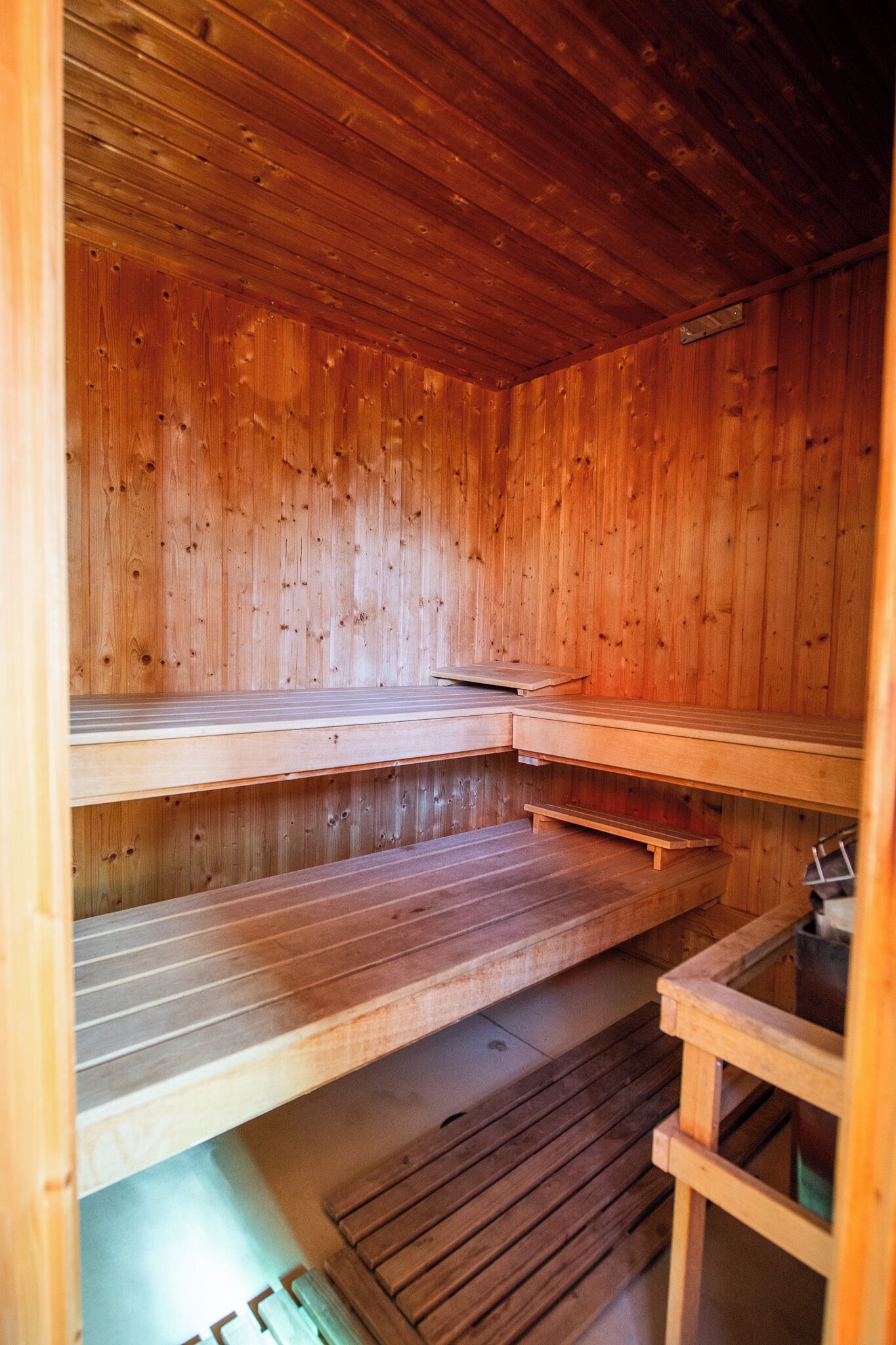 A sauna with wooden benches and a bench seat.