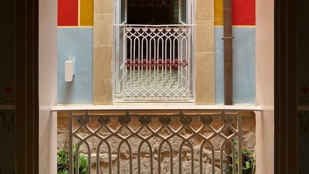 A window with a white metal railing and a small balcony. - The Musician Angels (Sogliano Cavour)