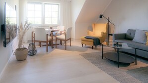 Un salon moderne comprenant un coin repas, un canapé et une table basse.