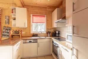 Enjoy cooking in this well-equipped kitchen with a sink, stove, and dishwasher.