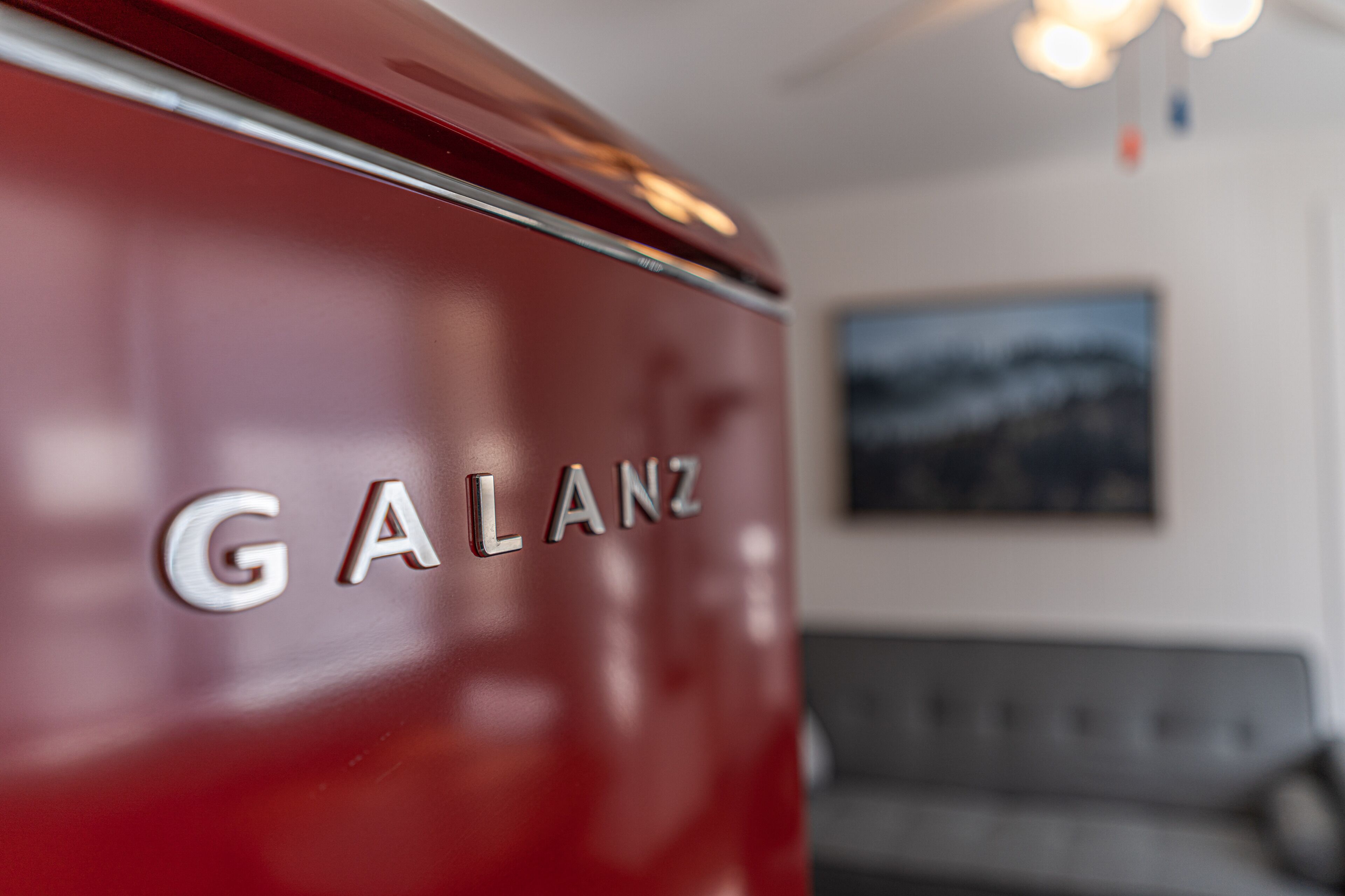 A close-up of a red vehicle with the brand name "GALANZ" on its side.