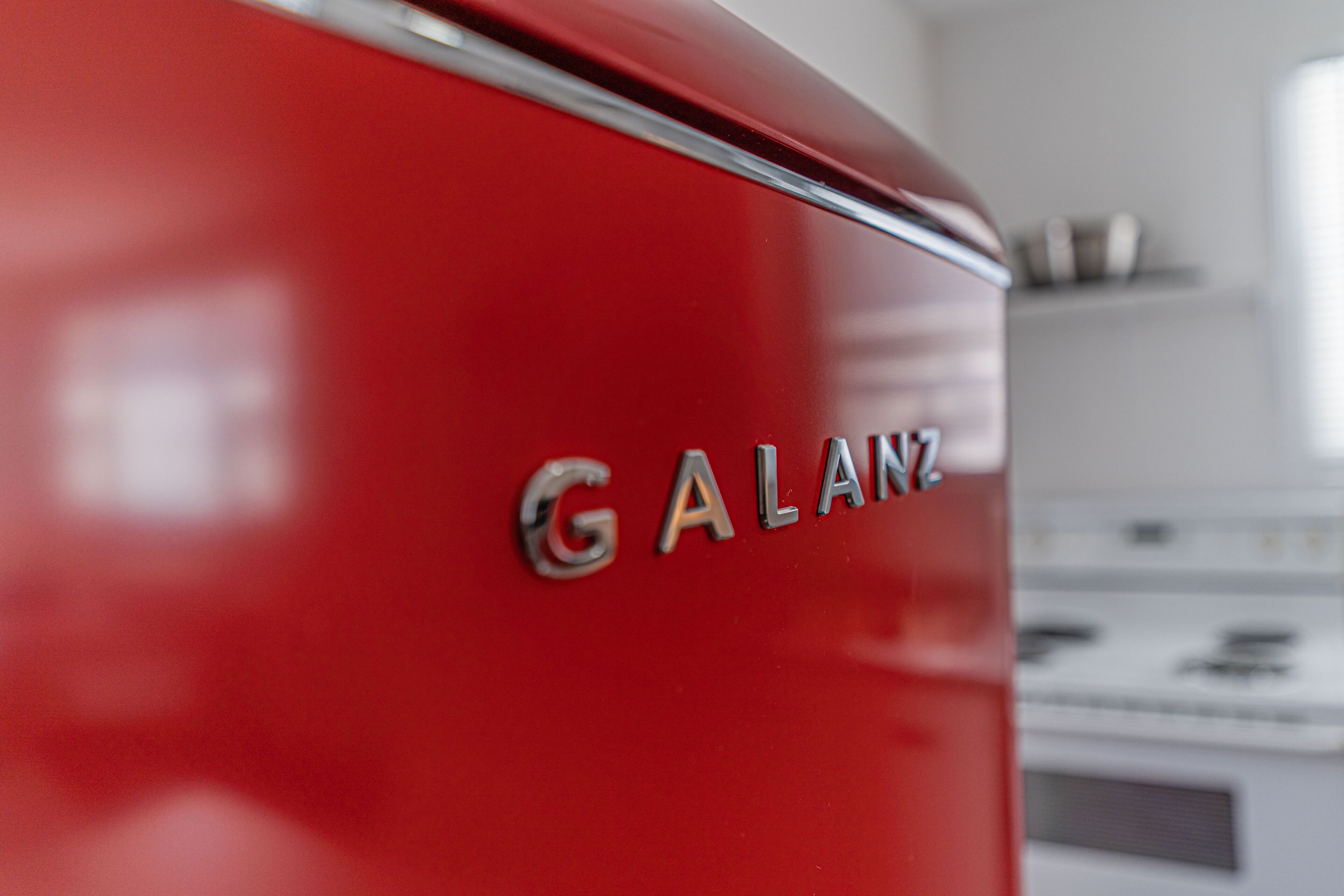 A close-up of a red vehicle with the word "GALANZ" on it.