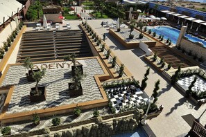 A resort with a pool, outdoor seating, and a checkered area.