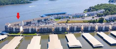 An aerial view of a waterfront residential area with multiple apartment buildings and a marina.