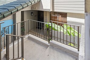A residential building with a balcony, a tiled roof, and a window with blinds. - New Listing: Spacious 2-bedroom Luxurious Kapalua Golf Villa (Lahaina)