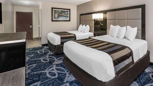 A hotel room with two beds, a TV, a framed picture on the wall, and a patterned carpet. - Comfort Inn & Suites Liverpool - Syracuse (Liverpool)