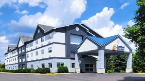 A multi-story hotel with a blue roof and a sign reading 'Comfort Suites.' - Comfort Inn & Suites Liverpool - Syracuse (Liverpool)
