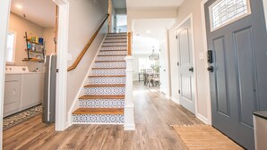 A staircase with patterned steps leading to a dining area. - KING Master En-Suite- BRAND NEW Home- Buffalo's Best Kept Secret! (Buffalo)