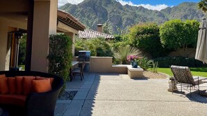 A patio with outdoor furniture, a grill, and a view of mountains. - Amazing 5 bedroom Indian Wells Country Club home with private backyard! (Indian Wells)