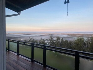 Enjoy breathtaking views of the surrounding landscape from this balcony.