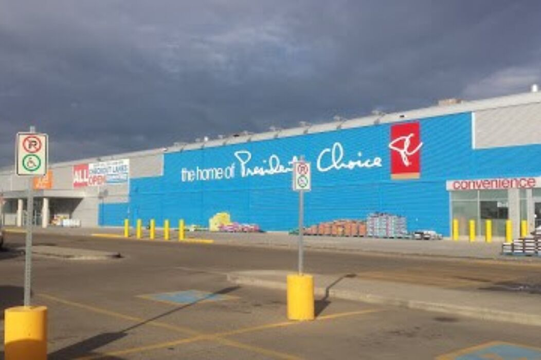A large retail store with a blue facade and signage for 'President Choice' and 'Convenience'.