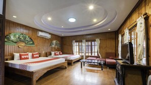 A hotel room with two beds, a TV, and a wooden floor. - Blue Resort and Spa Koh Chang (Ko Chang)