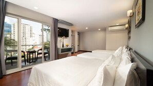 A hotel room with a balcony, a desk, a TV, and two beds. - Le Cocon Boutique Hotel (Phnom Penh)