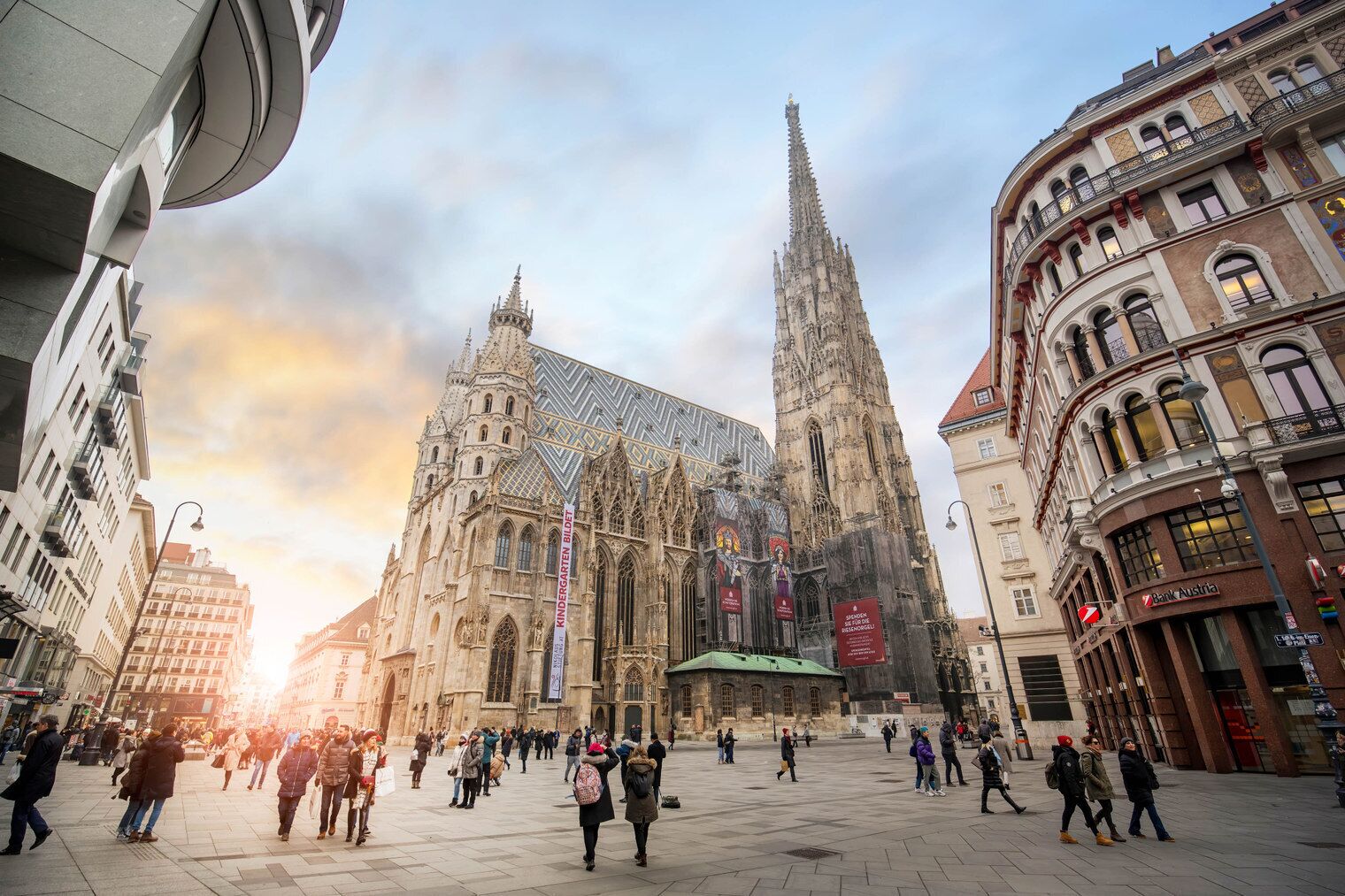 A historic cathedral with intricate architecture, a central spire, and banners.