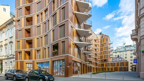 A modern multi-story building with balconies, a 3D cinema, and a parking area. - Chic Innere Stadt 1BR w/ Gym & Doorman, walk to Graben, by Blueground (Vienna)