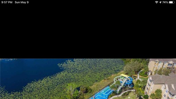 An aerial view of a resort with multiple swimming pools, a water park, and lush greenery. - Mickey’s Vacation Villa-Premium- Minutes from Disney World with private pool! (Kissimmee)