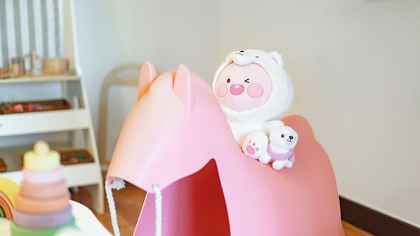 A pink play structure with a bear figure on top. - Chuncheon El Dorado Kid's Pension (Chuncheon)