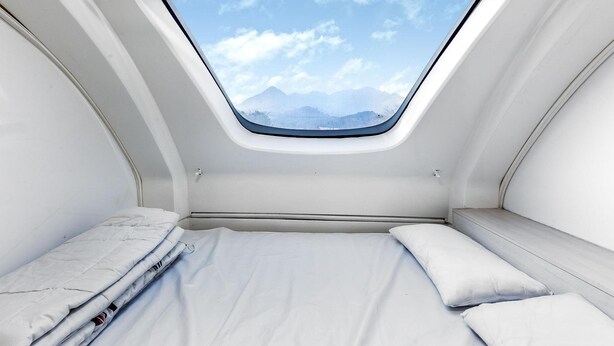 A compact, modern room with a skylight, a bed, and a bench. - Gapeyong Unak Holiday Caravan (Gapyeong)