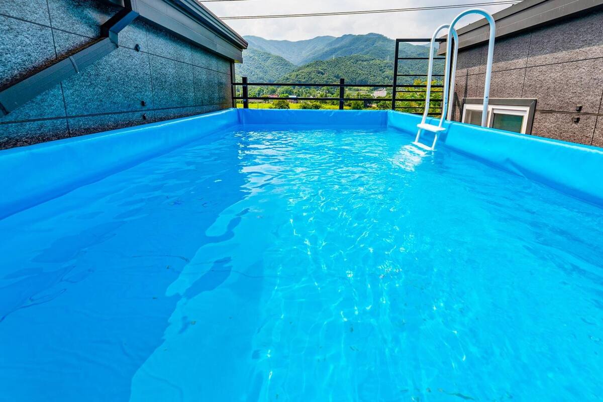 A swimming pool with a clear view of mountains in the background.
