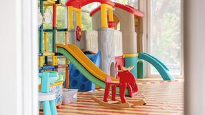 A children's play area with a slide, climbing structures, and a rocking horse. - Gyeongju Soraedanga Pension (Gyeongju)