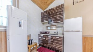 A compact kitchen with a built-in stove, a sink, and a refrigerator. - Suncheonman Muhan Dojan Pension (Suncheon)