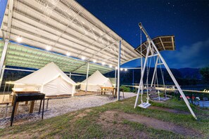 A covered outdoor area with tents, a swing set, and a grill. - Yangyang Slowstay Pension (Yangyang)