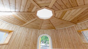 A wooden interior with a hexagonal skylight and a central arched window. - Nami Island Healing Leisure Camping&glamping (Gapyeong)