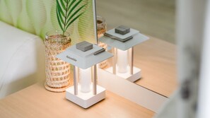A modern, minimalist table with a white base and a small, rectangular object on top. - Gapyeong Art Pension (Gapyeong)