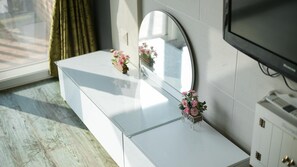 A modern bathroom with a white vanity, a large mirror, and a small potted plant. - Ganghwa Badatgashimteo Pension (Incheon)