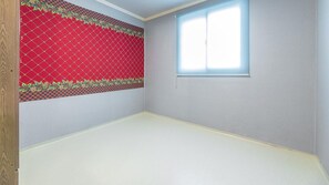 A room with a red patterned wall, a window, and a plain floor. - Ganghwa Badatgashimteo Pension (Incheon)