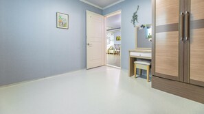 A hallway with a door leading to a room, a wooden wardrobe, and a small desk with a chair. - Ganghwa Badatgashimteo Pension (Incheon)