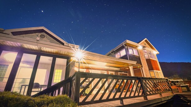A two-story house with a balcony and large windows, set against a night sky with stars. - Gapyeong Poongkyungmaru Pension (Gapyeong)