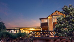 A two-story house with a prominent brick section and a large window. - Gapyeong Poongkyungmaru Pension (Gapyeong)