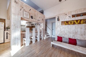 A modern interior with a wooden accent wall, a bench, and a staircase. - Ganghwa Vintage Box Pension (Incheon)
