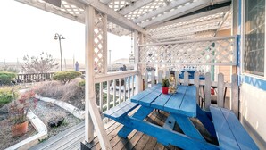 A covered outdoor area with a blue picnic table and a potted plant. - Ganghwa Edenjungwon Pension (Incheon)