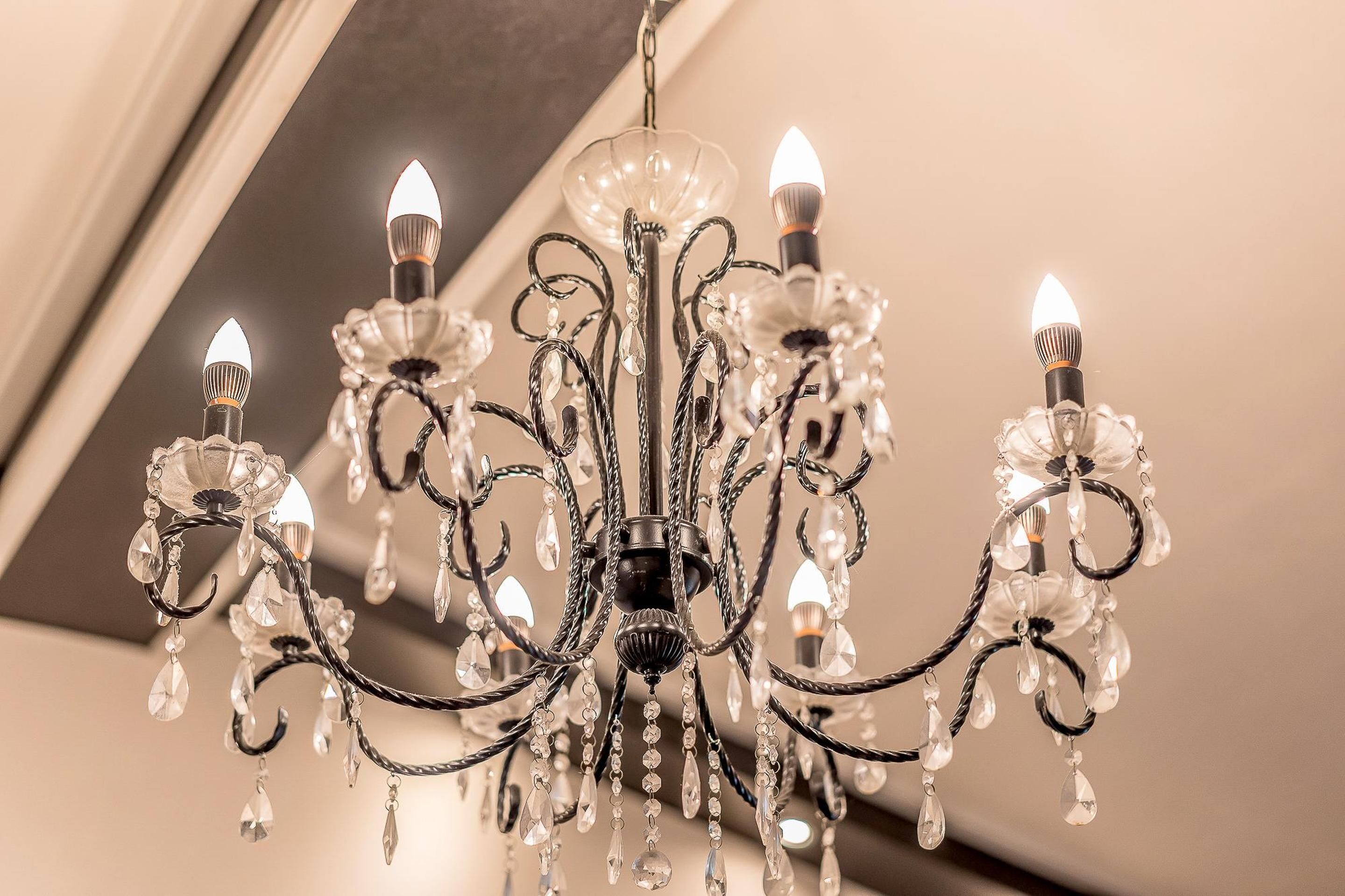 A chandelier with multiple arms and crystal decorations.