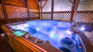 A hot tub with a control panel, surrounded by wooden walls and a lattice window. - Pocheon Arumdri Pension (Pocheon)