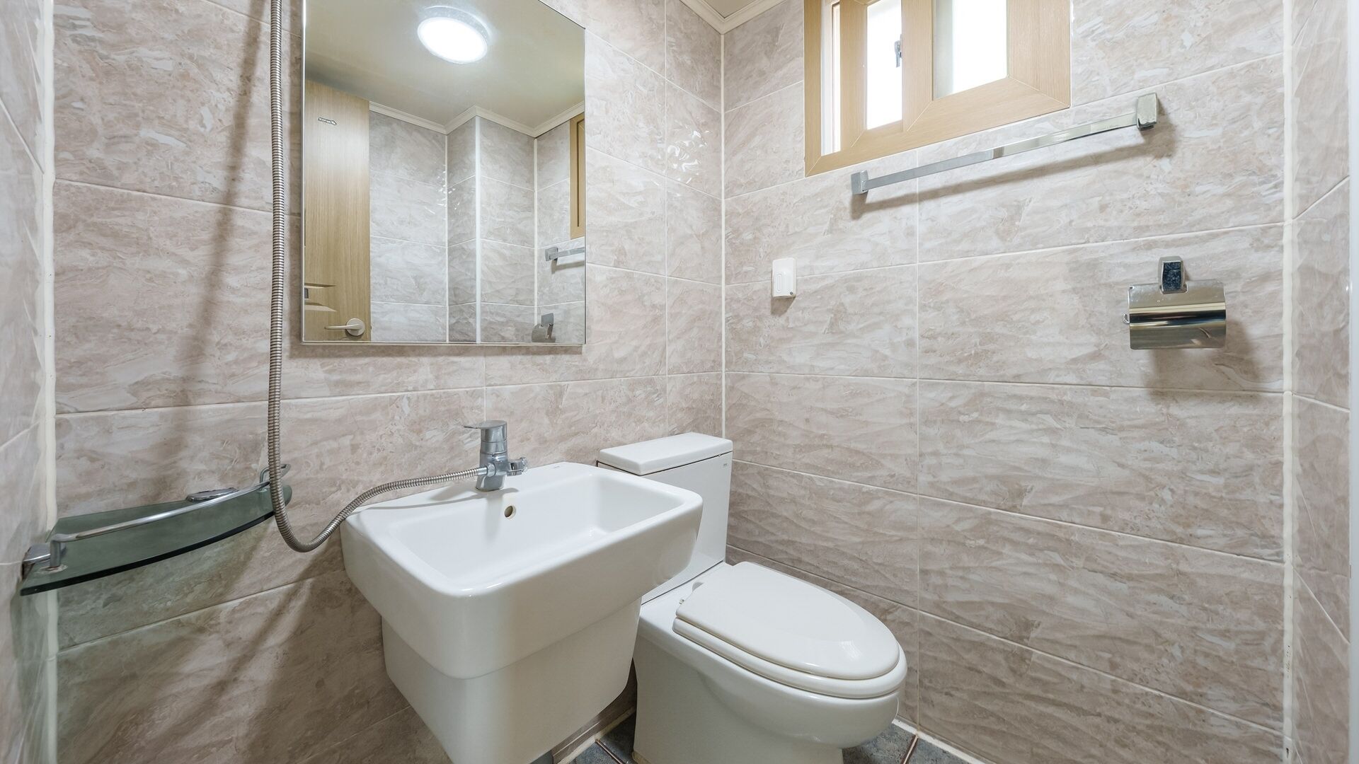 A bathroom with a sink, toilet, and a shower.