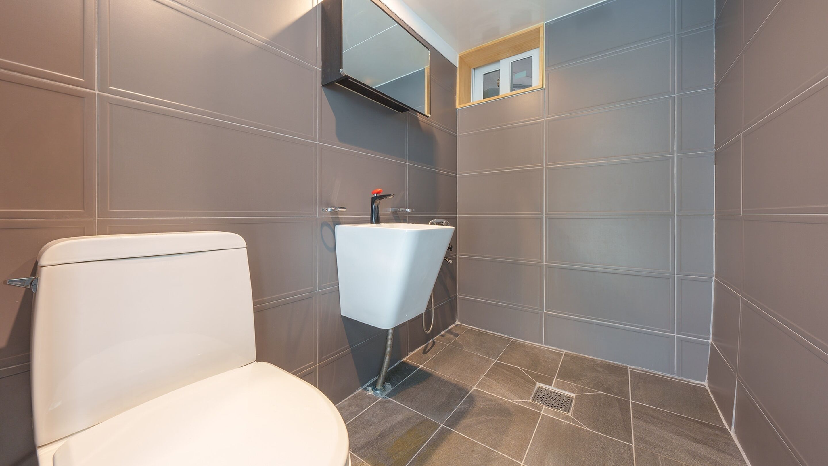 A bathroom with a toilet, a sink, and a shower.
