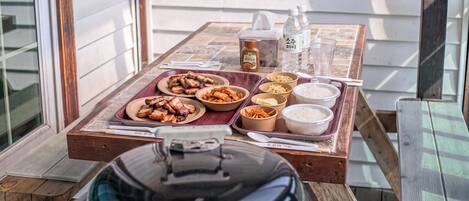 A dining table with various dishes, condiments, and a water bottle.
